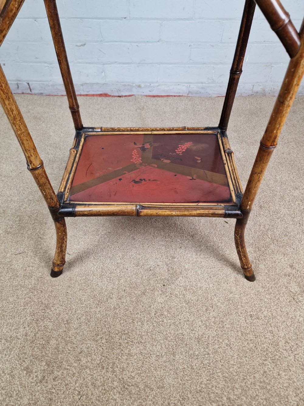 A 19th-century Aesthetic Movement side table crafted from bamboo with a dark lacquered top panel featuring floral hand-painted details and an undertier. View VIII