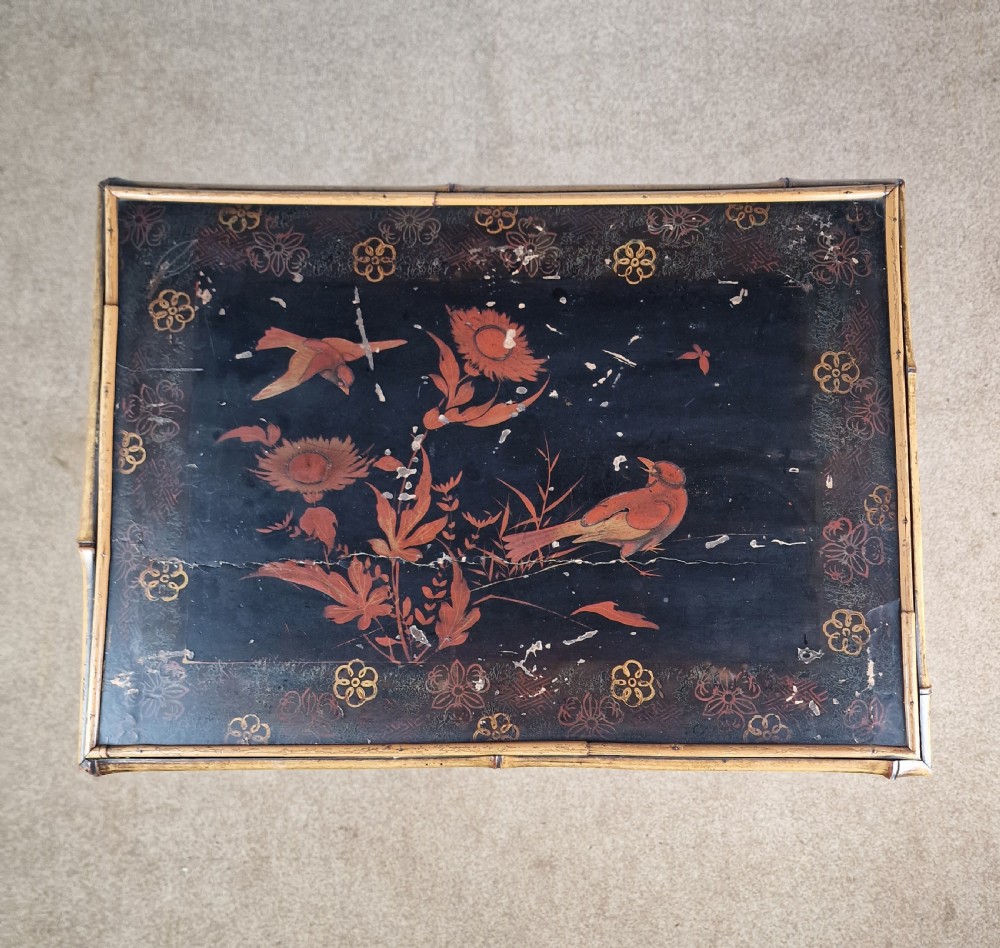 A 19th-century Aesthetic Movement side table crafted from bamboo with a dark lacquered top panel featuring floral hand-painted details and an undertier. View IX