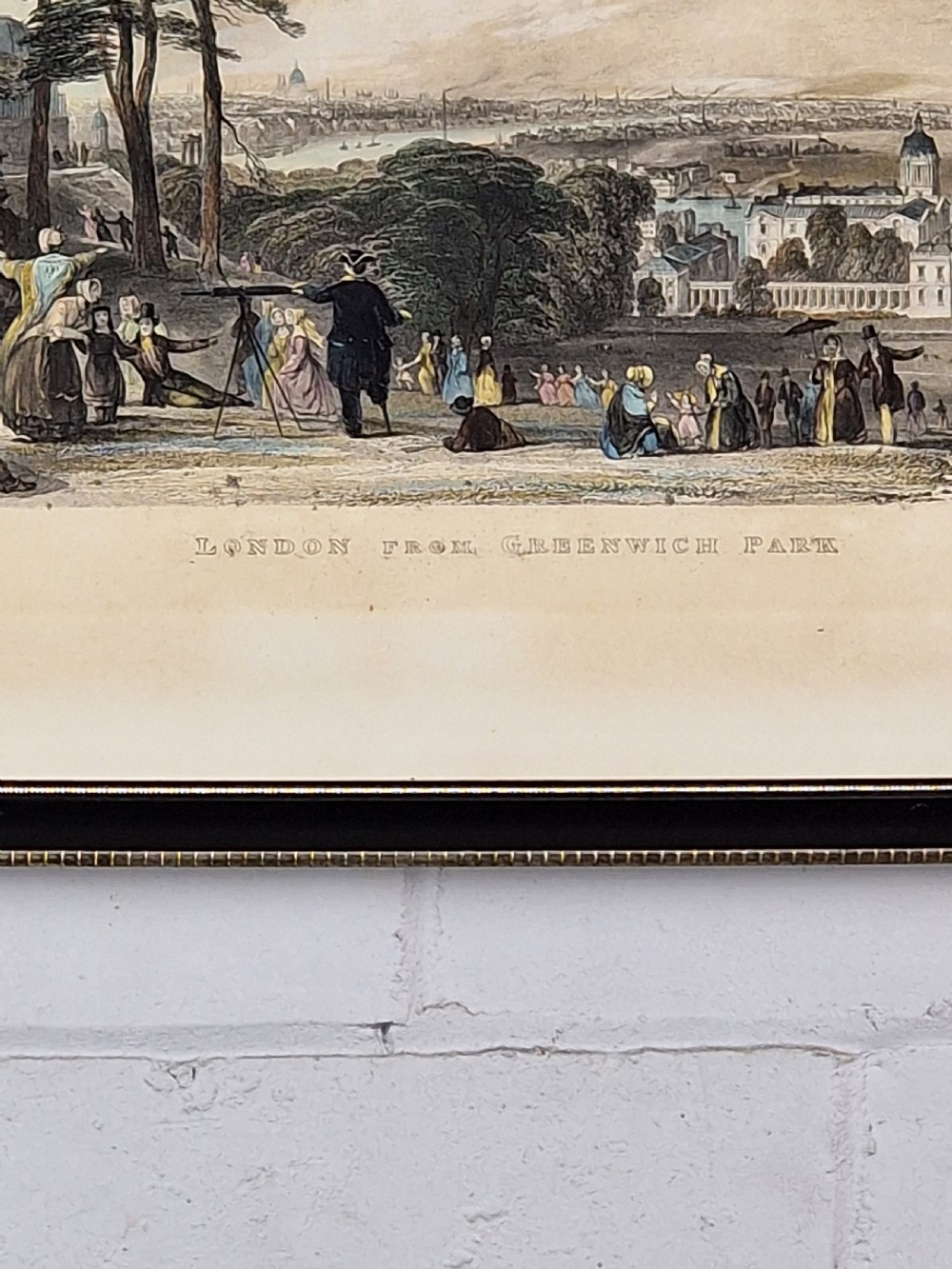 A framed 19th-century hand-coloured etching depicting figures gathered in Greenwich Park looking towards the London skyline. View II