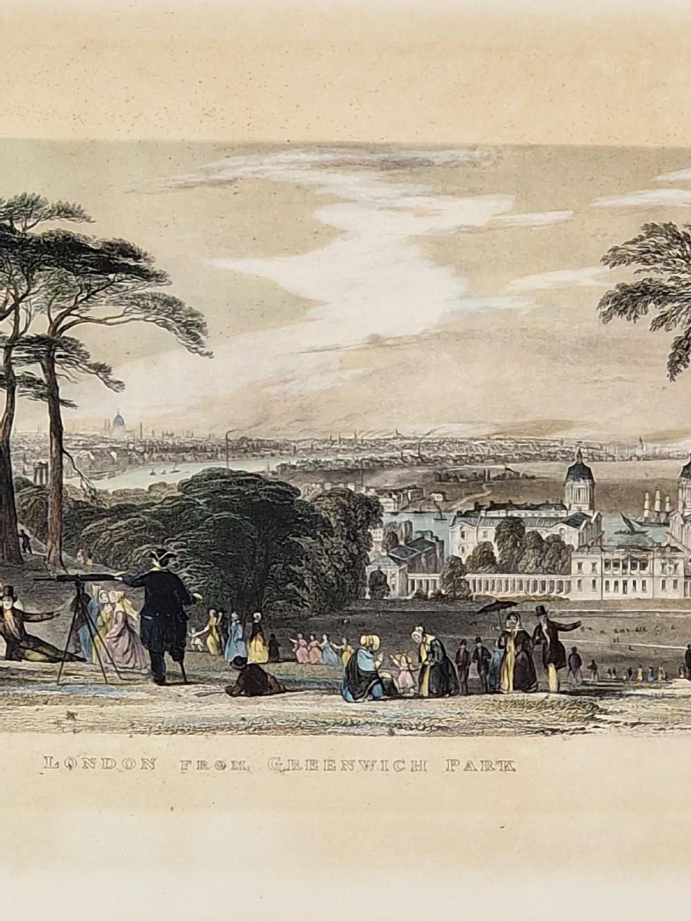 A framed 19th-century hand-coloured etching depicting figures gathered in Greenwich Park looking towards the London skyline. View IV