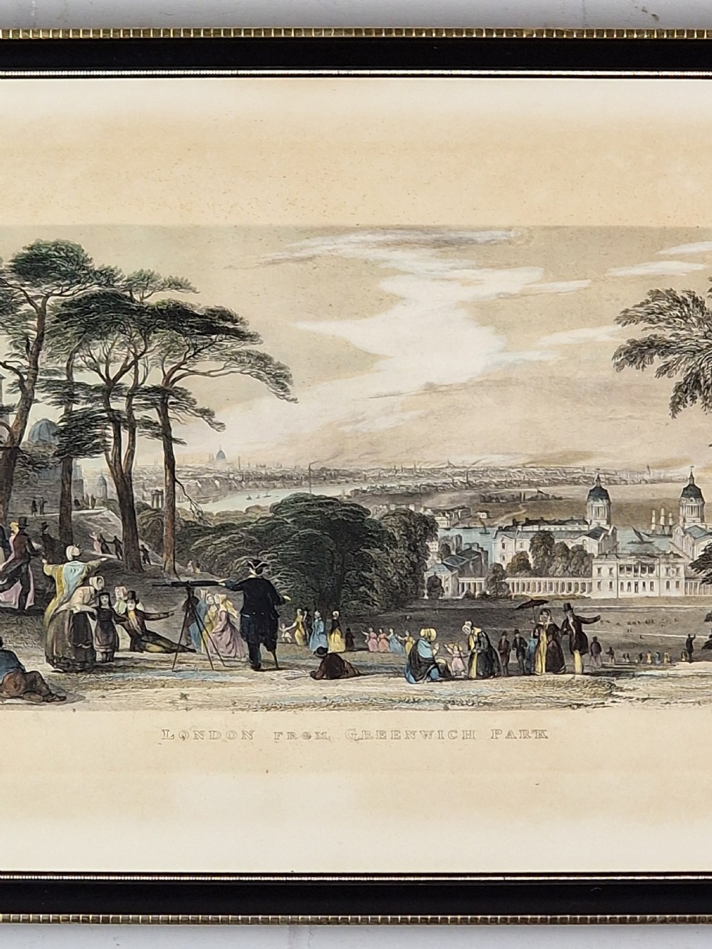 A framed 19th-century hand-coloured etching depicting figures gathered in Greenwich Park looking towards the London skyline. View V