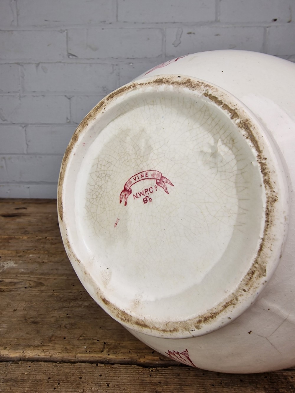 A Victorian cream ceramic jug decorated with a red transferware pattern of grapes and vine leaves. View IX