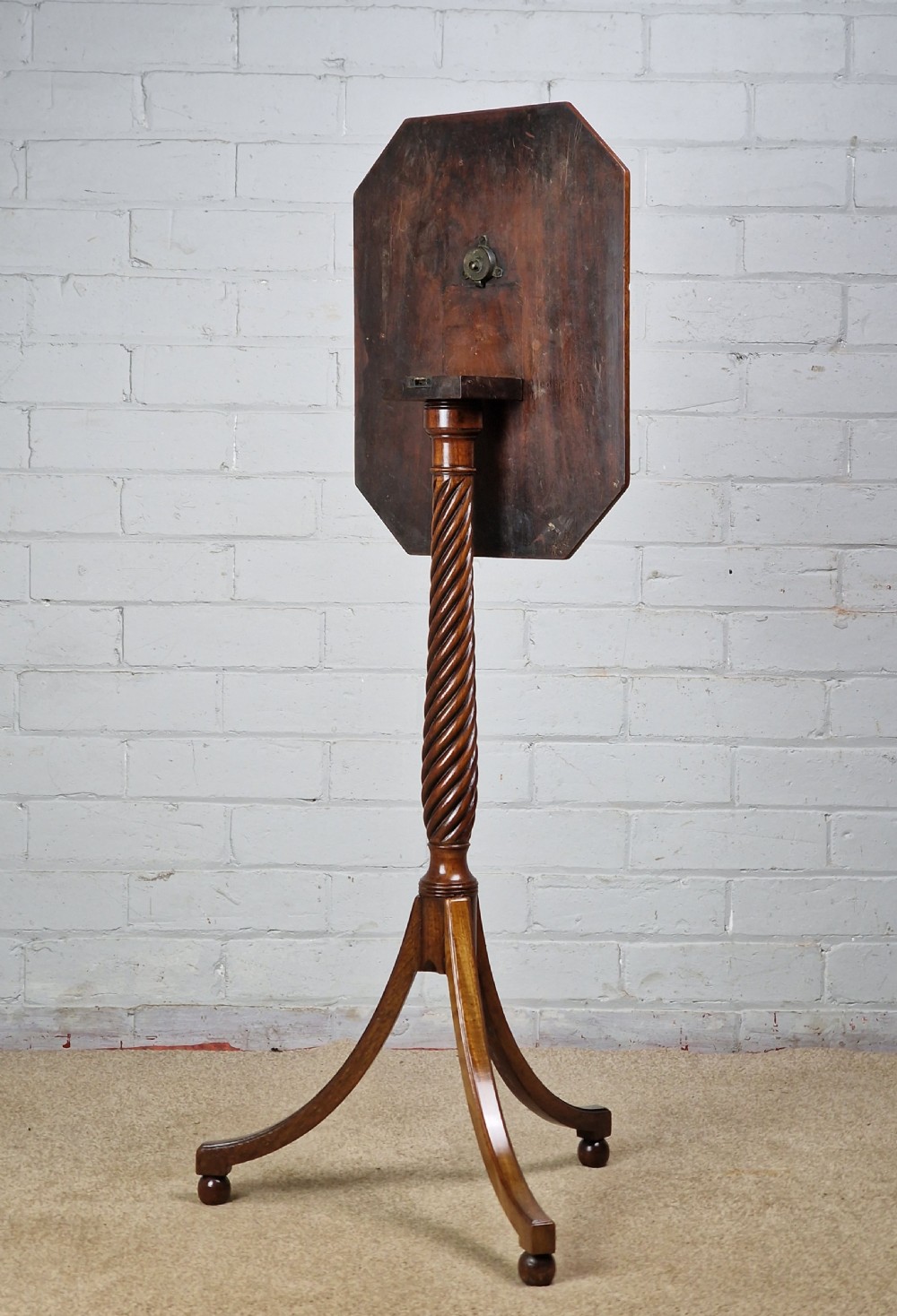 An early nineteenth-century Regency mahogany tripod table featuring an octagonal top with boxwood stringing, a spiral-turned stem, and downcurved tripod legs. View II