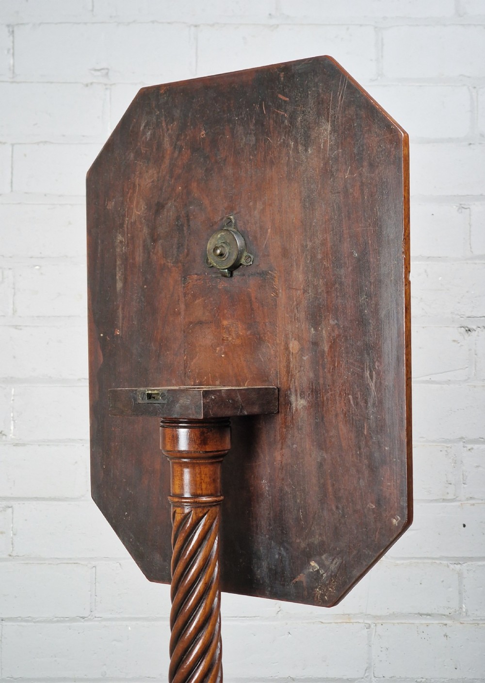 An early nineteenth-century Regency mahogany tripod table featuring an octagonal top with boxwood stringing, a spiral-turned stem, and downcurved tripod legs. View III