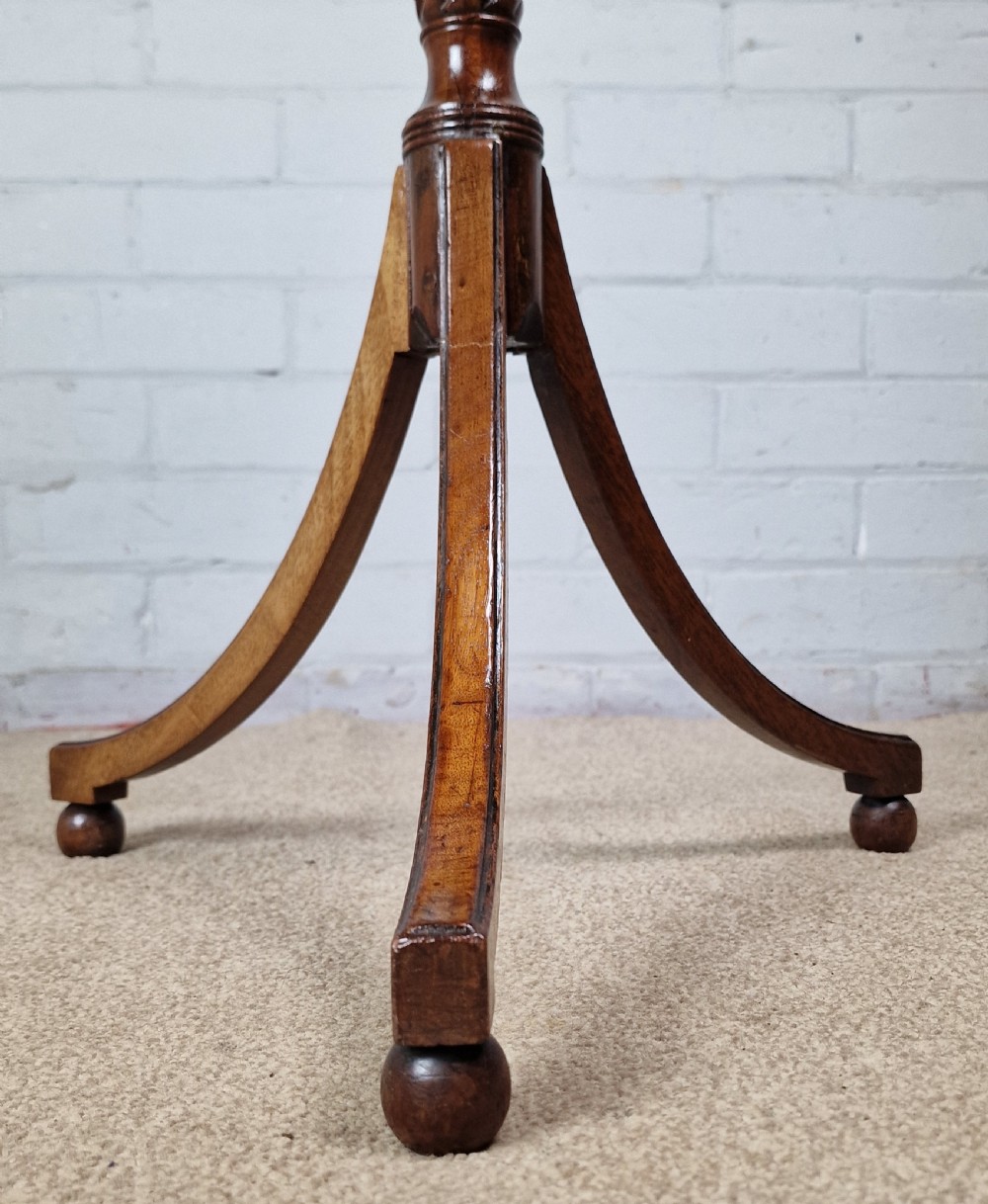 An early nineteenth-century Regency mahogany tripod table featuring an octagonal top with boxwood stringing, a spiral-turned stem, and downcurved tripod legs. View VI