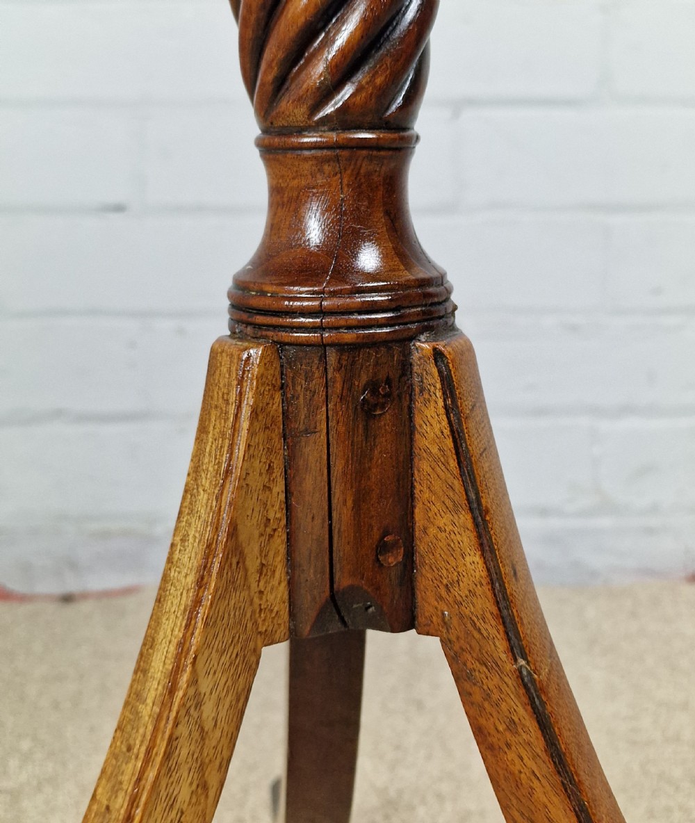 An early nineteenth-century Regency mahogany tripod table featuring an octagonal top with boxwood stringing, a spiral-turned stem, and downcurved tripod legs. View VIII