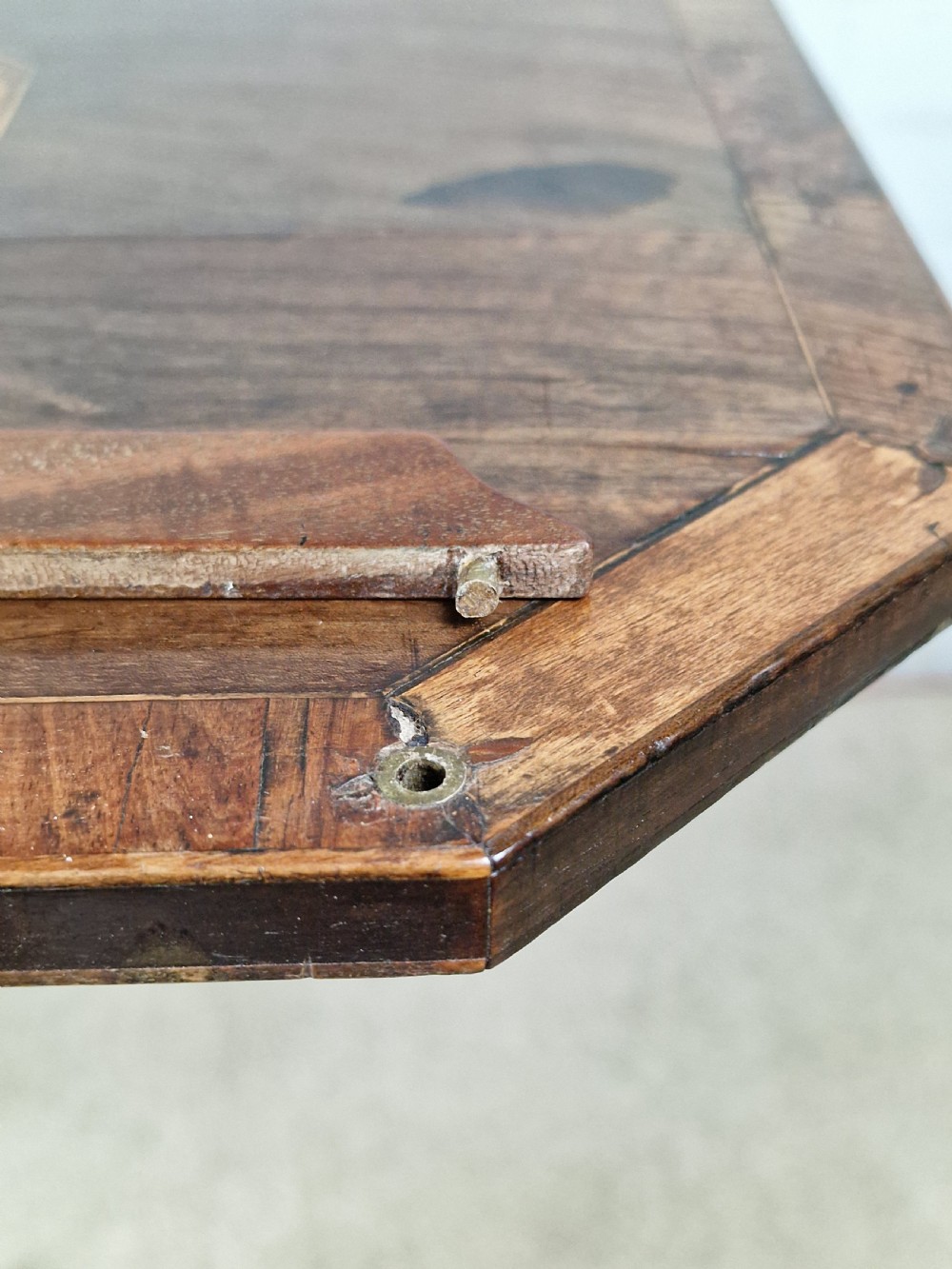 An early 19th-century Regency mahogany reading table featuring an octagonal inlaid tilt top with a raised book lip, supported by a turned column on tripod legs. View III