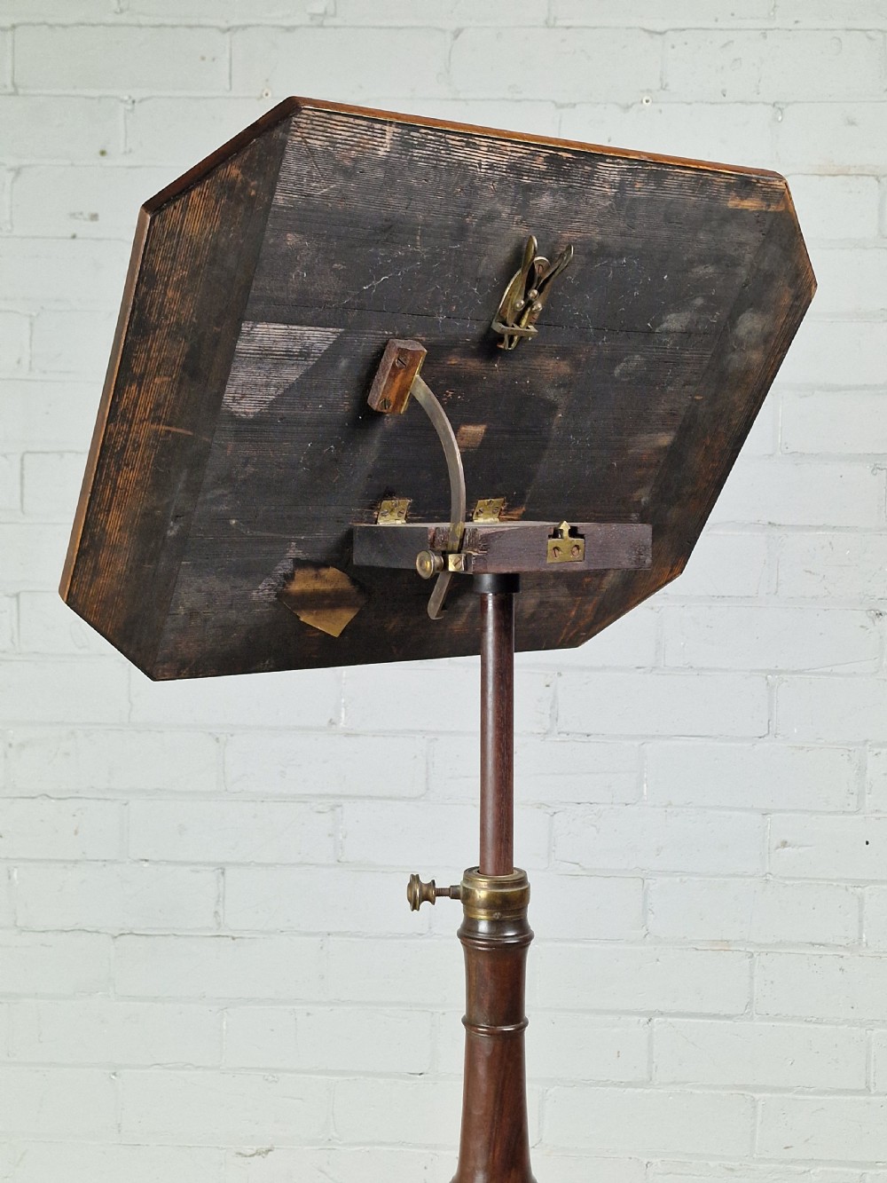 An early 19th-century Regency mahogany reading table featuring an octagonal inlaid tilt top with a raised book lip, supported by a turned column on tripod legs. View IV