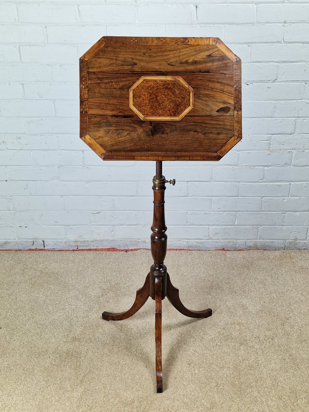 An early 19th-century Regency mahogany reading table featuring an octagonal inlaid tilt top with a raised book lip, supported by a turned column on tripod legs. View VII