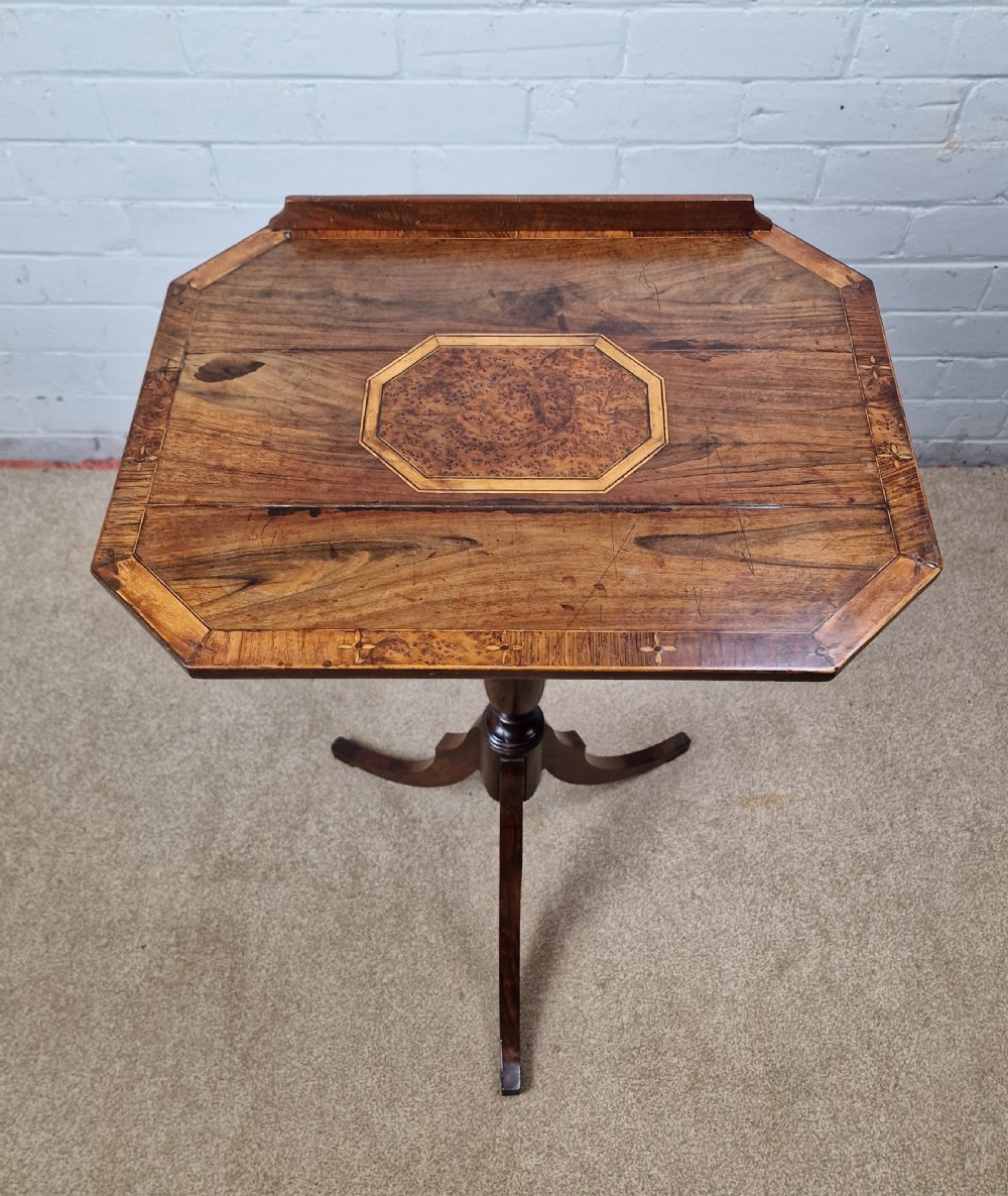 An early 19th-century Regency mahogany reading table featuring an octagonal inlaid tilt top with a raised book lip, supported by a turned column on tripod legs. View VIII
