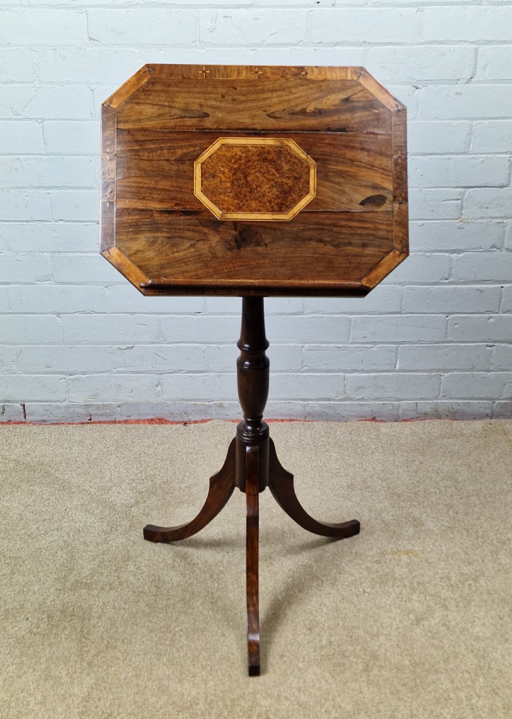 An early 19th-century Regency mahogany reading table featuring an octagonal inlaid tilt top with a raised book lip, supported by a turned column on tripod legs. View IX