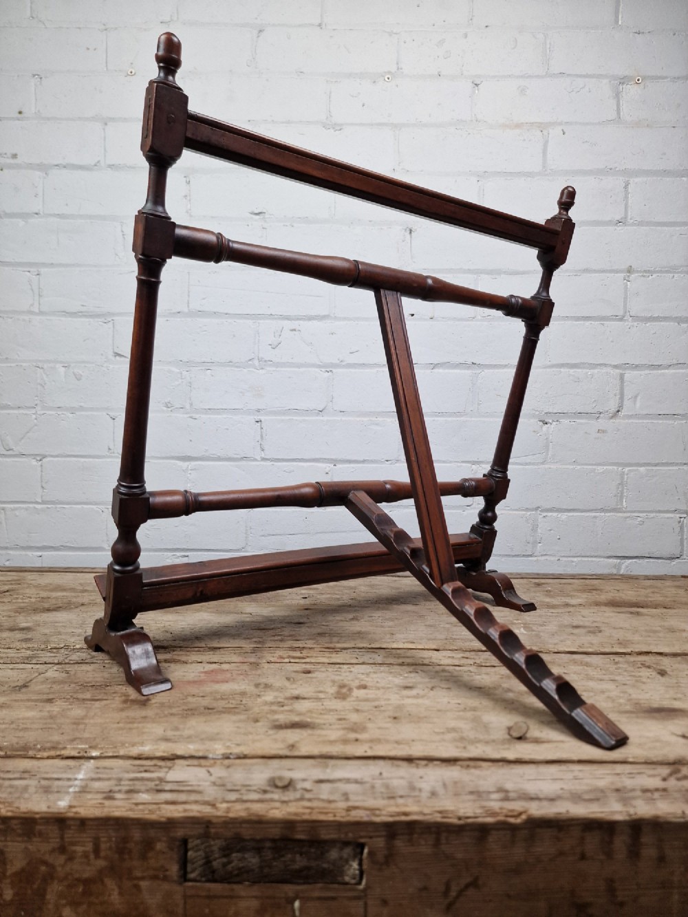 A nineteenth-century mahogany table-top easel featuring turned wooden side supports, finials, a front shelf ledge, and an adjustable rear prop stand. View IV