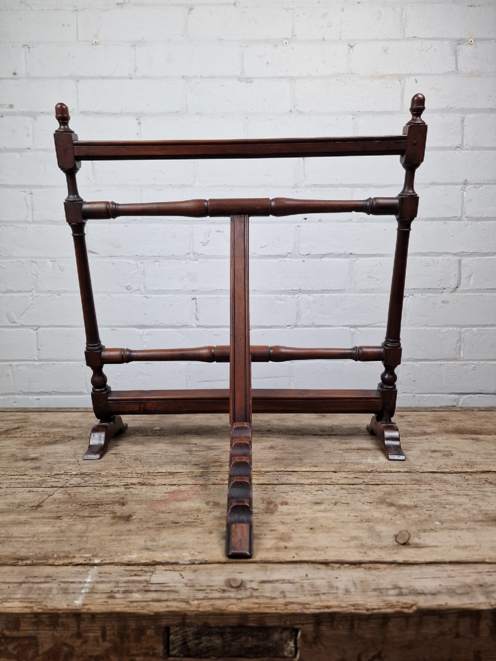 A nineteenth-century mahogany table-top easel featuring turned wooden side supports, finials, a front shelf ledge, and an adjustable rear prop stand. View V