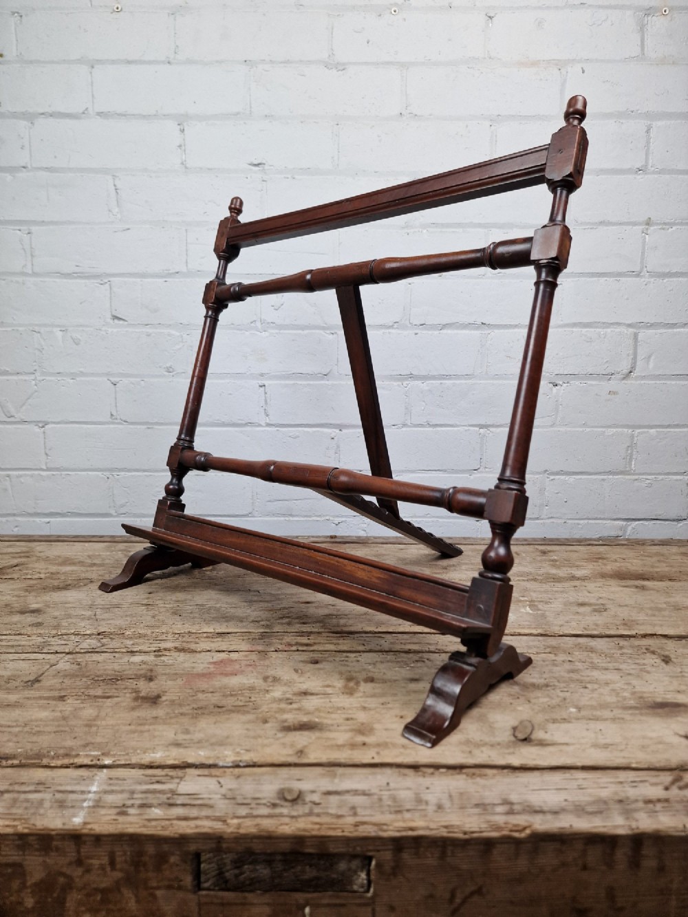 A nineteenth-century mahogany table-top easel featuring turned wooden side supports, finials, a front shelf ledge, and an adjustable rear prop stand. View IX