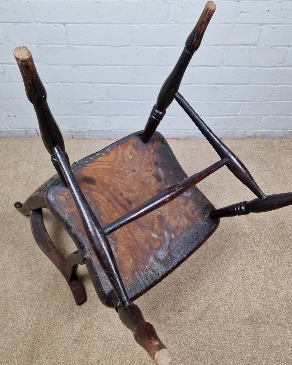 A Victorian dark brown elm and beech Oxford bar back Windsor armchair featuring turned spindles, shaped armrests, and turned legs with stretchers. View VIII