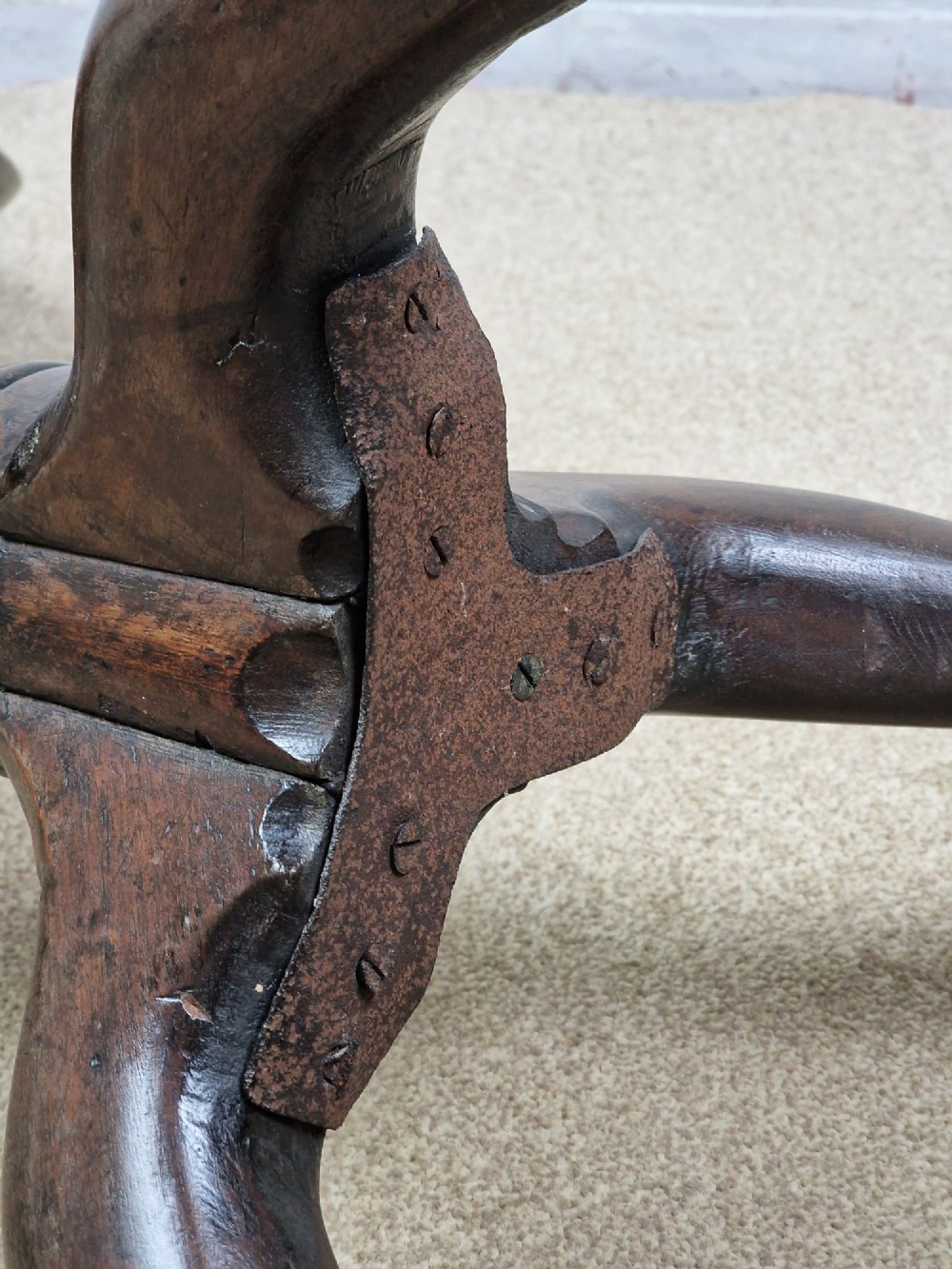 A late eighteenth-century Georgian mahogany tripod table shown with its circular dished top tilted vertically above a turned baluster pedestal on three cabriole legs. View VIII
