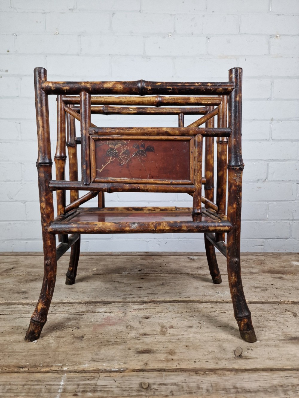 A nineteenth-century tiger bamboo magazine rack featuring a mottled cane frame with lacquered side panels. View IV