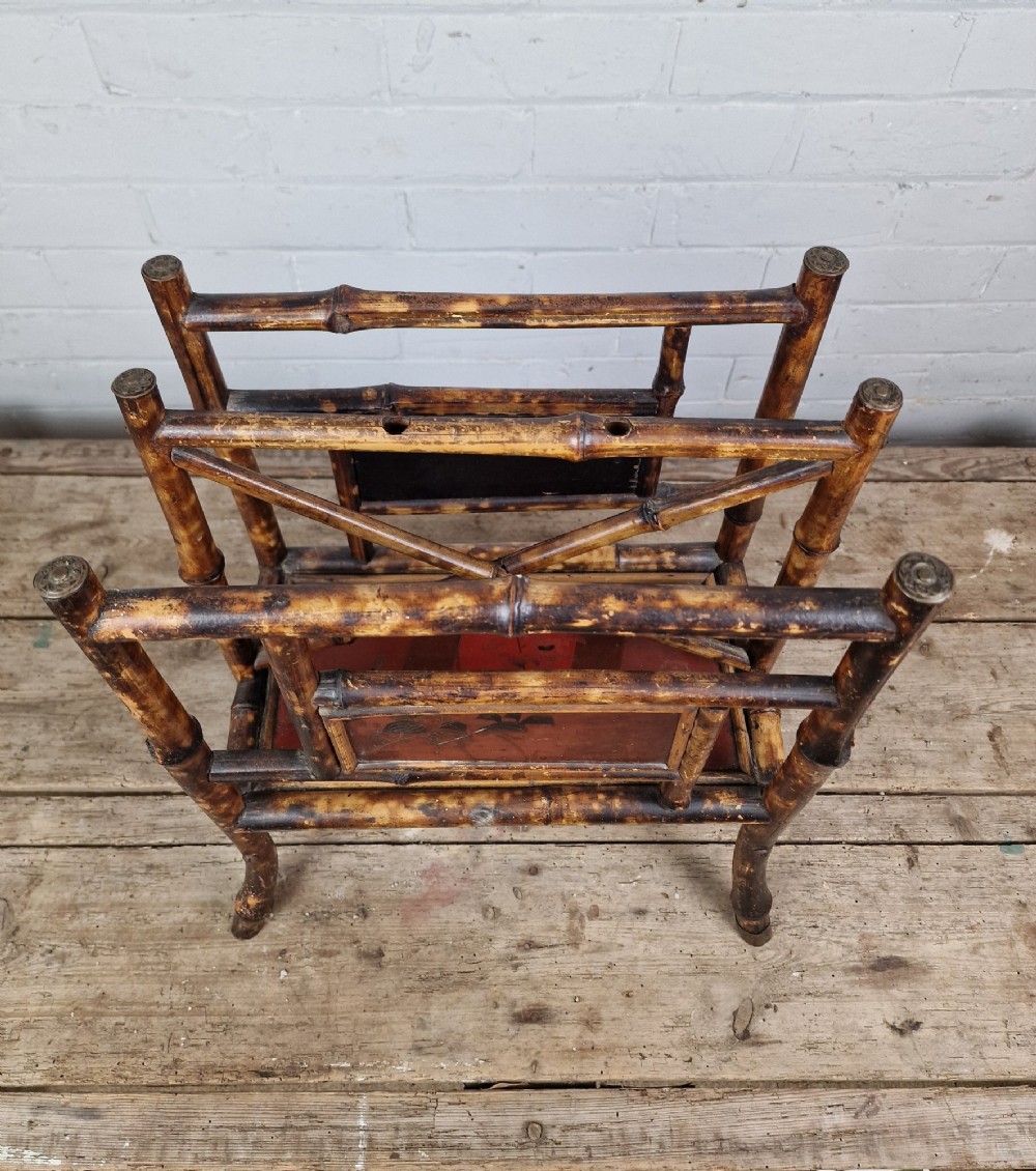 A nineteenth-century tiger bamboo magazine rack featuring a mottled cane frame with lacquered side panels. View V