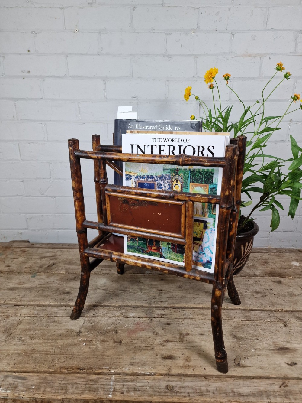 A nineteenth-century tiger bamboo magazine rack featuring a mottled cane frame with lacquered side panels. View II