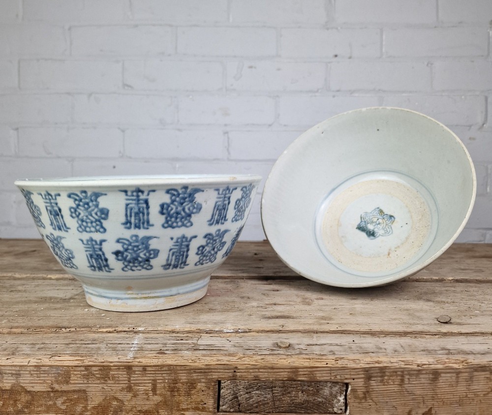 A pair of round Chinese provincial porcelain bowls featuring underglaze blue character motifs around the exterior on an off-white surface. View III