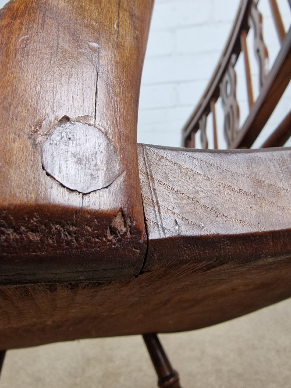 A mid-19th-century wooden Mendlesham armchair featuring a squared backrest with turned wooden spheres, pierced splats, curved arms, and a shaped seat on turned legs. View VII