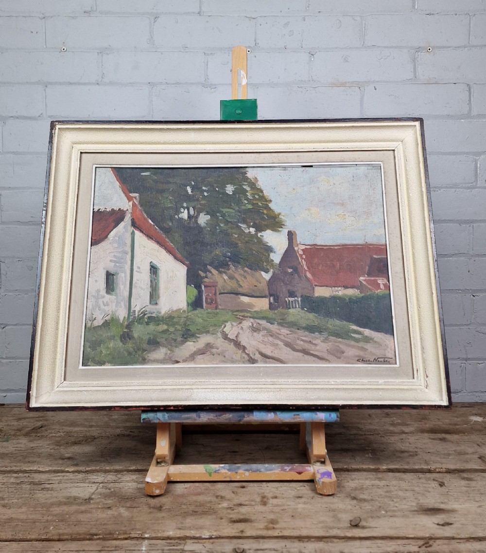 An oil painting on board depicting a Belgian farmyard scene with whitewashed cottages and trees, housed in a wide off-white molded frame. View IV
