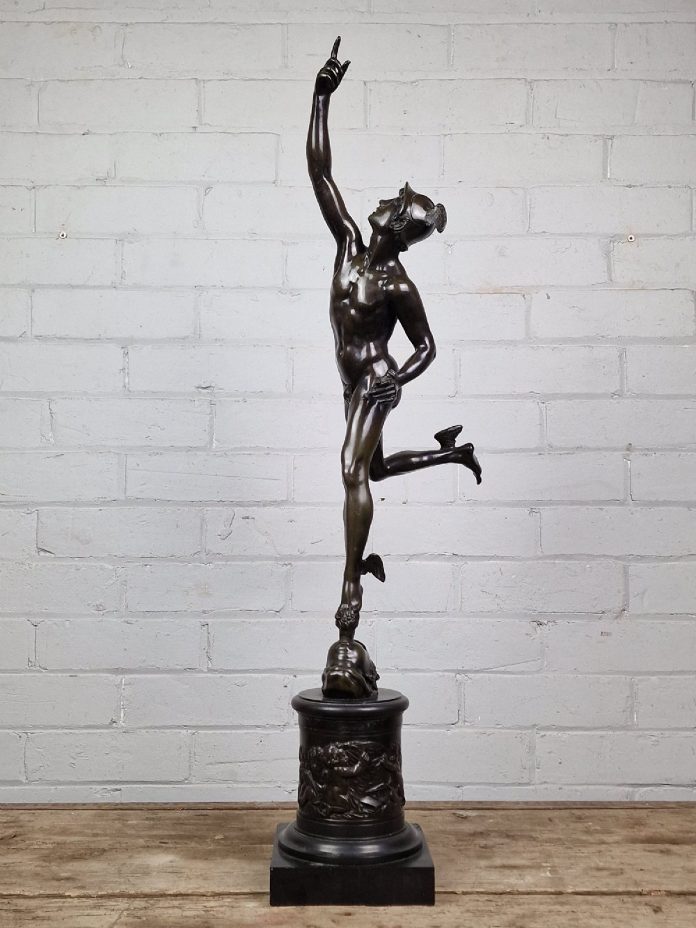 A pair of late 19th-century patinated dark bronze classical figures depicting Mercury and Fortuna, mounted on relief-decorated cylindrical pedestals and square black bases. View V