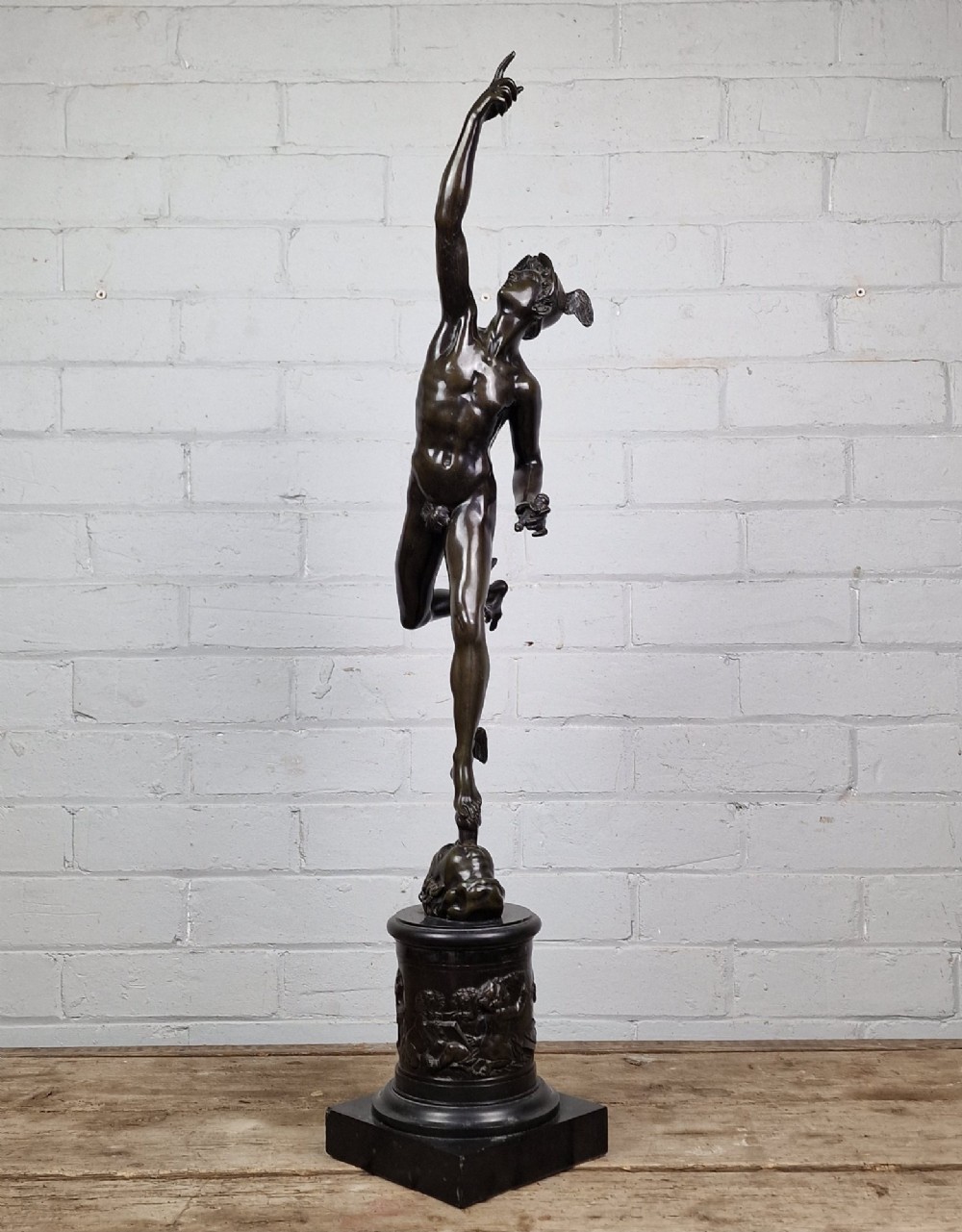 A pair of late 19th-century patinated dark bronze classical figures depicting Mercury and Fortuna, mounted on relief-decorated cylindrical pedestals and square black bases. View VII