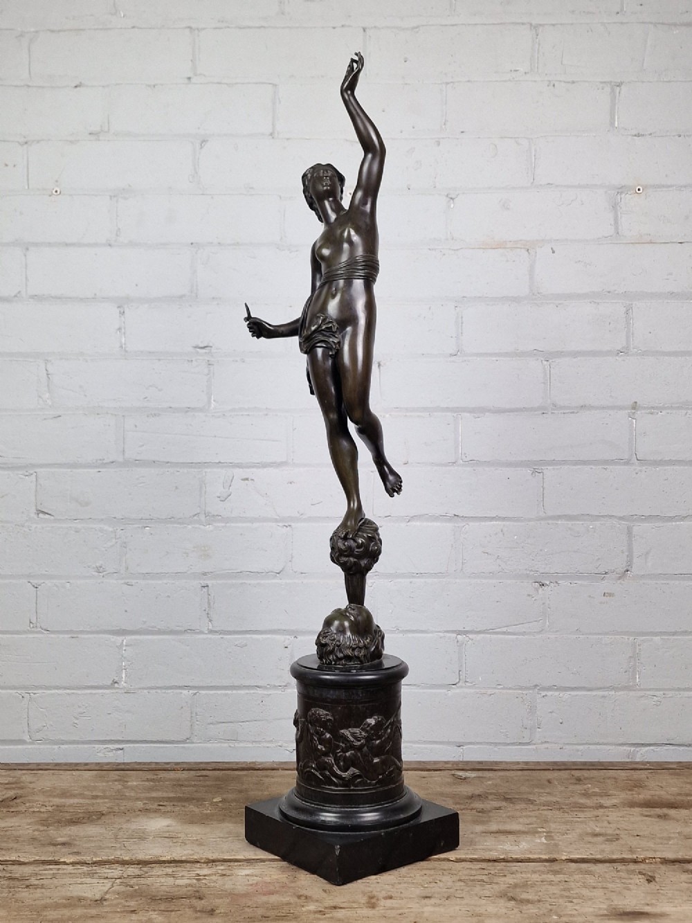 A pair of late 19th-century patinated dark bronze classical figures depicting Mercury and Fortuna, mounted on relief-decorated cylindrical pedestals and square black bases. View VIII