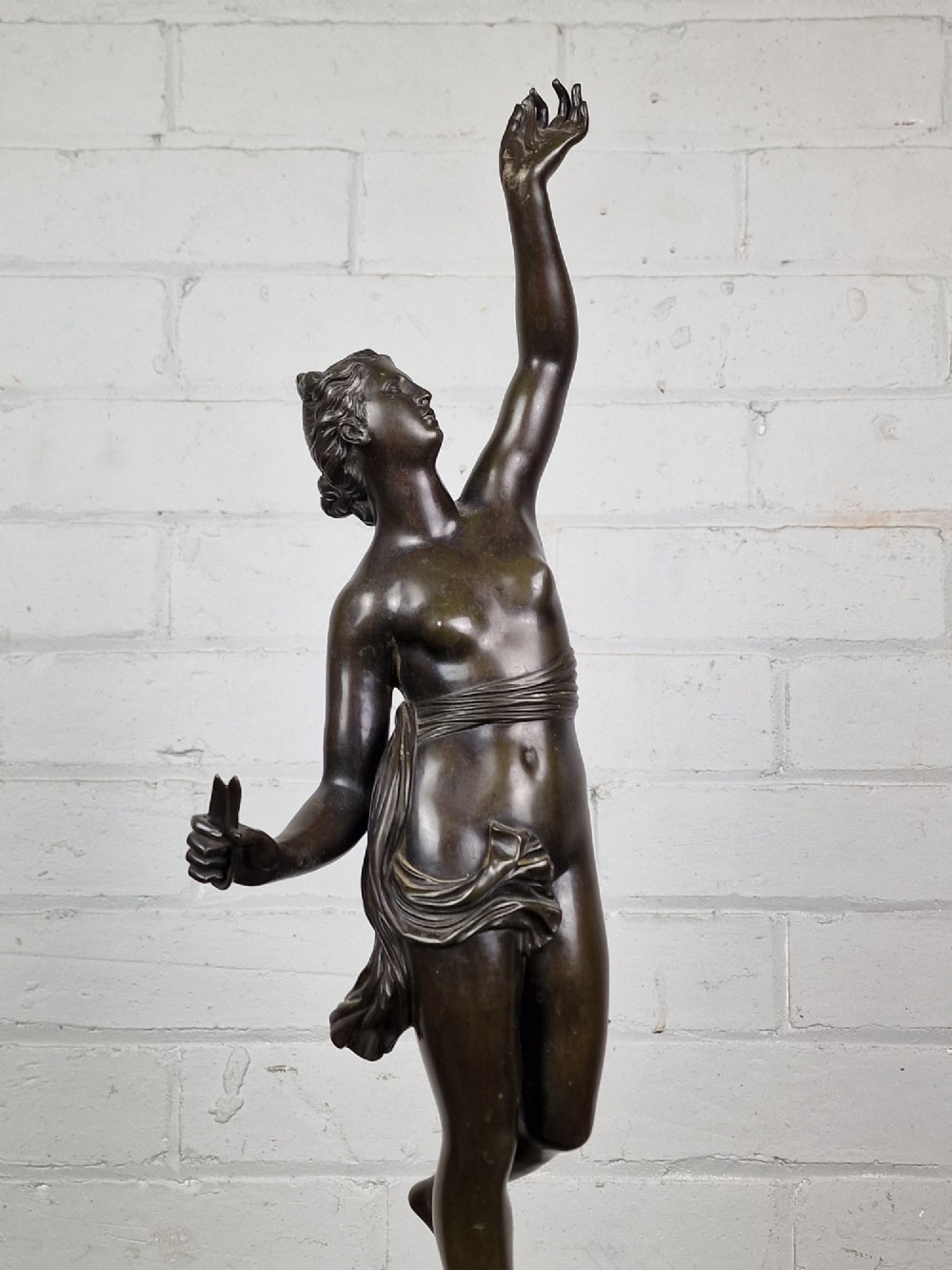 A pair of late 19th-century patinated dark bronze classical figures depicting Mercury and Fortuna, mounted on relief-decorated cylindrical pedestals and square black bases. View IX