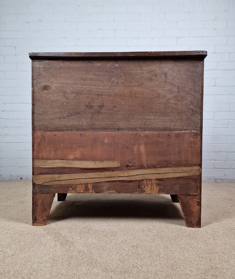 A George III mahogany bow front chest of drawers featuring four graduated drawers with dark turned wooden handles and splayed bracket feet. View VIII