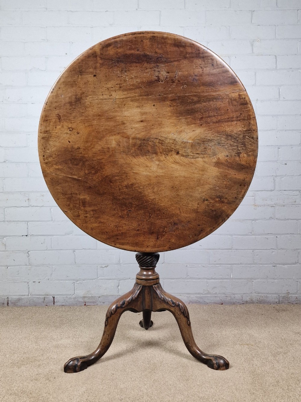 An 18th-century George II walnut tilt-top table featuring a circular top resting on a spiral-twisted column, carved cabriole legs, and claw and ball feet. View IV