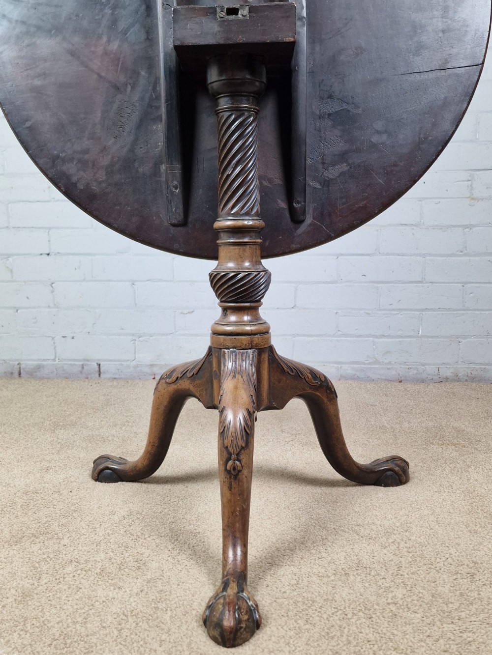 An 18th-century George II walnut tilt-top table featuring a circular top resting on a spiral-twisted column, carved cabriole legs, and claw and ball feet. View VII