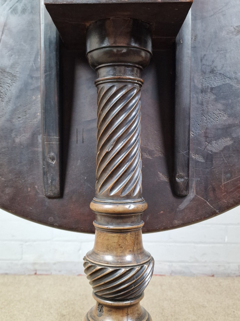 An 18th-century George II walnut tilt-top table featuring a circular top resting on a spiral-twisted column, carved cabriole legs, and claw and ball feet. View VIII