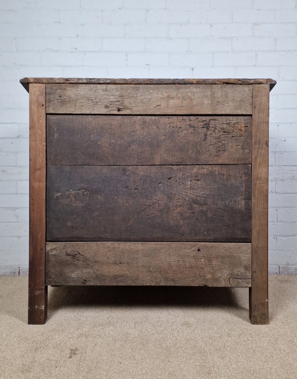 An antique French provincial two-door wooden side cabinet featuring carved panel doors, iron escutcheons, and short cabriole legs. View VIII