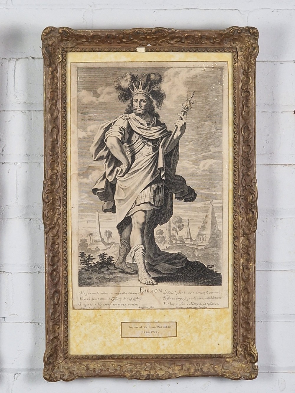 A pair of framed monochrome antique engravings depicting classical male figures set within carved ornate giltwood frames. View III