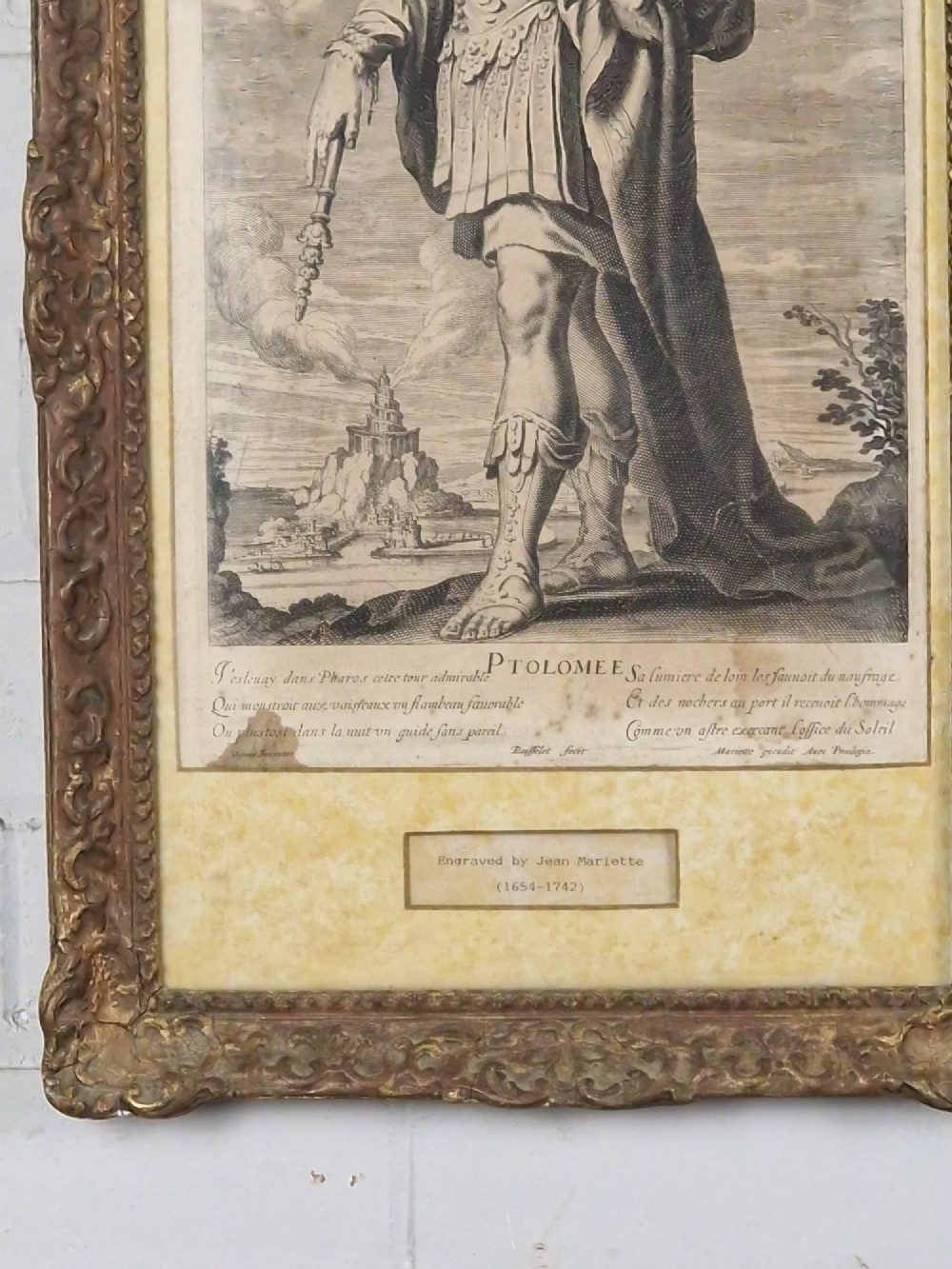 A pair of framed monochrome antique engravings depicting classical male figures set within carved ornate giltwood frames. View IV
