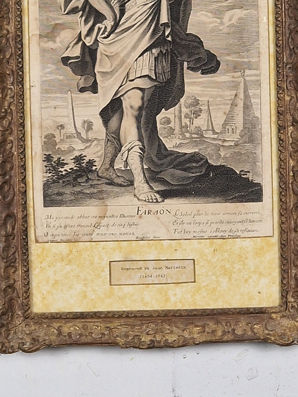 A pair of framed monochrome antique engravings depicting classical male figures set within carved ornate giltwood frames. View V