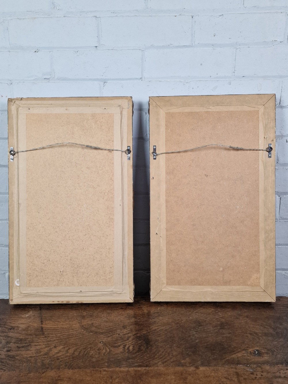 A pair of framed monochrome antique engravings depicting classical male figures set within carved ornate giltwood frames. View VI