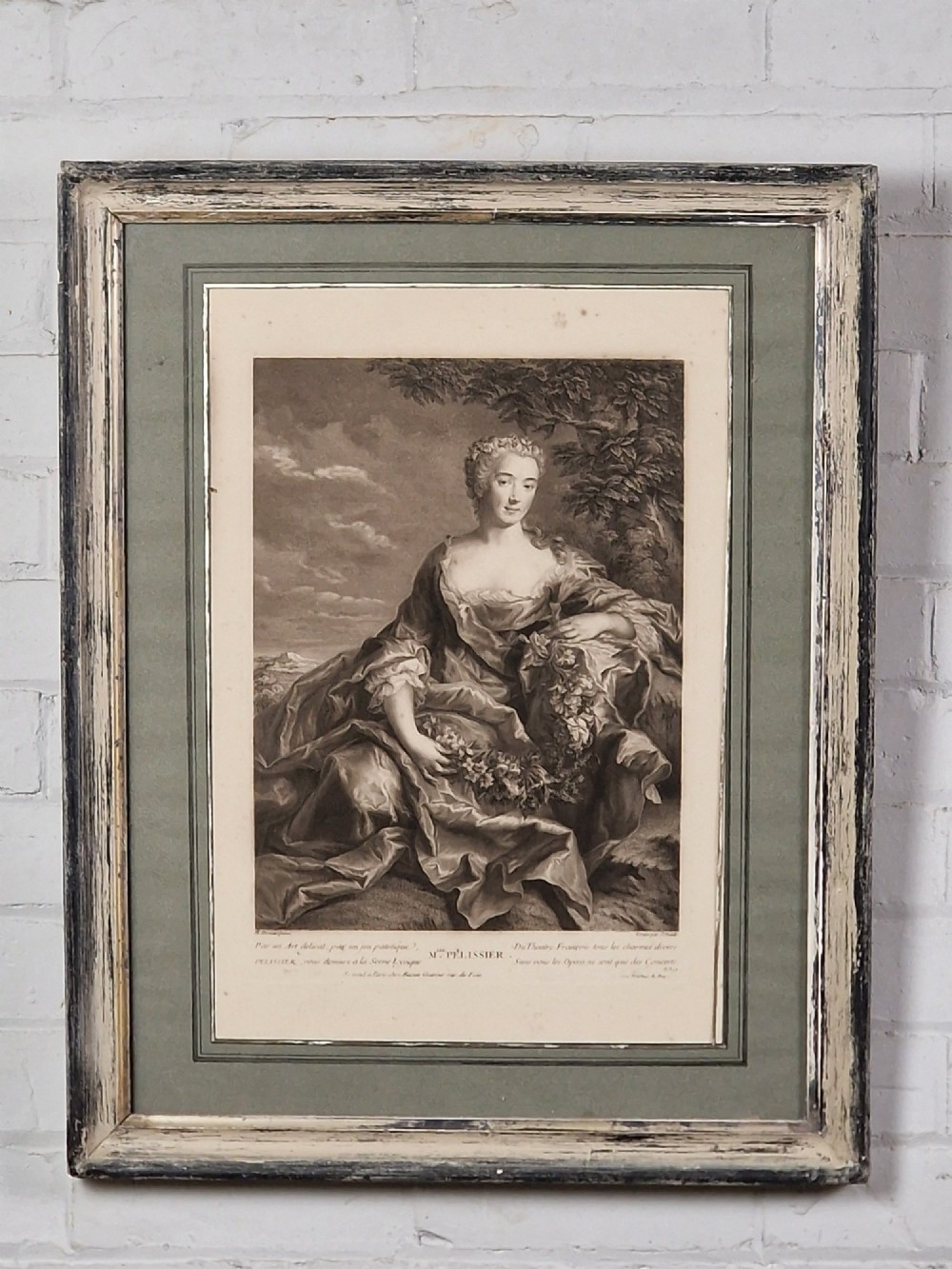 A pair of framed 18th-century French portrait engravings featuring seated female figures, presented in distressed wooden frames with green and cream double mounts. View II