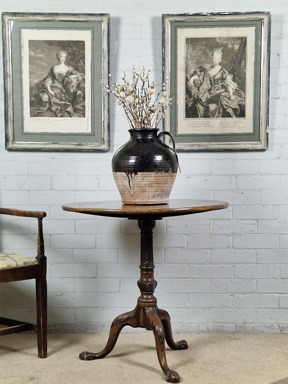 A pair of framed 18th-century French portrait engravings featuring seated female figures, presented in distressed wooden frames with green and cream double mounts. View VII