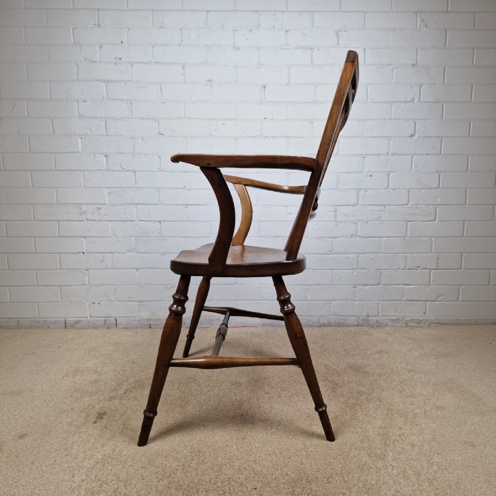 A mid-19th-century wooden Mendlesham armchair featuring a squared backrest with turned wooden spheres, pierced splats, curved arms, and a shaped seat on turned legs. View IV