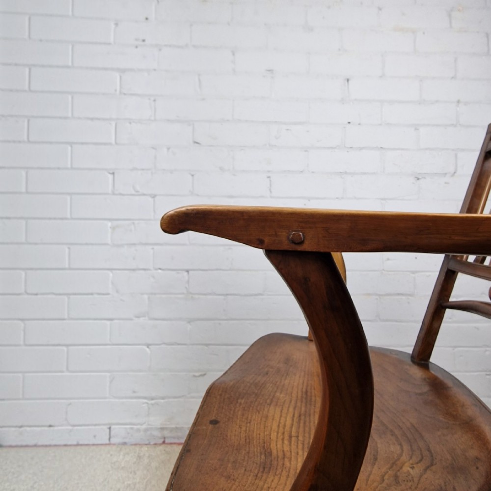 A mid-19th-century wooden Mendlesham armchair featuring a squared backrest with turned wooden spheres, pierced splats, curved arms, and a shaped seat on turned legs. View V