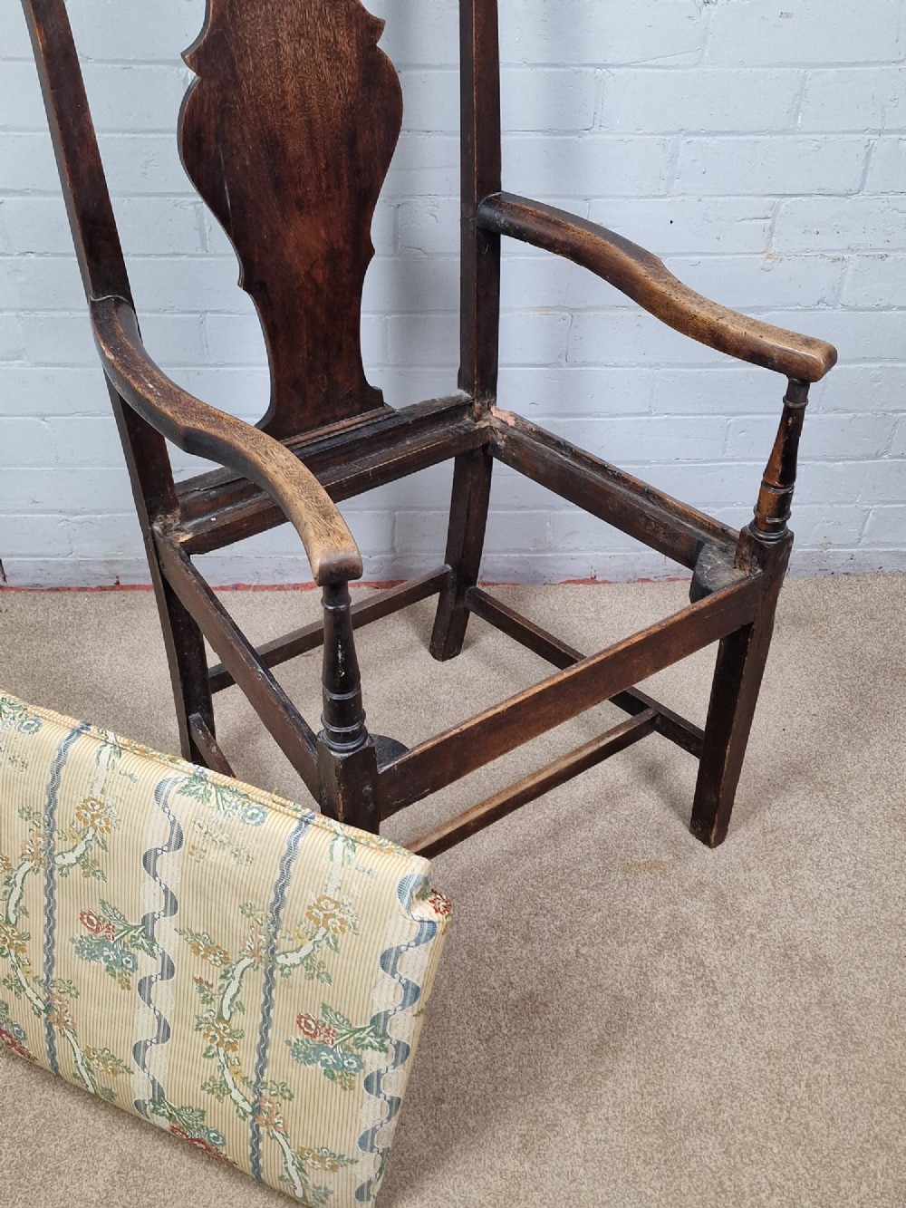 A late eighteenth-century dark oak armchair featuring a vase-shaped splat back, turned arm supports, and a patterned floral fabric drop-in seat. View IV