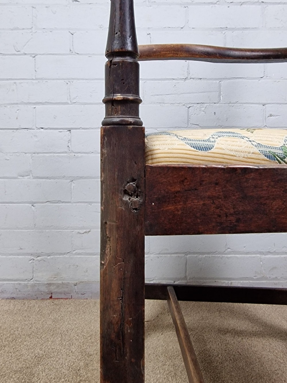 A late eighteenth-century dark oak armchair featuring a vase-shaped splat back, turned arm supports, and a patterned floral fabric drop-in seat. View VIII