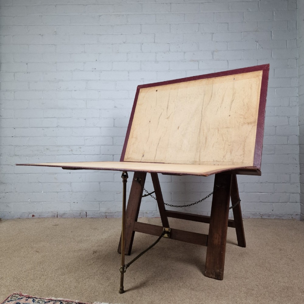 A late 19th-century mahogany folio stand with burgundy leather panels, an adjustable brass ratchet arm, and a wooden trestle frame. View II