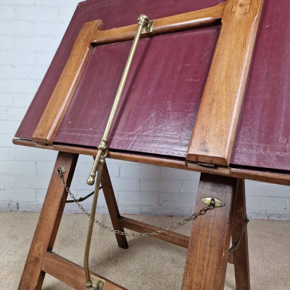 A late 19th-century mahogany folio stand with burgundy leather panels, an adjustable brass ratchet arm, and a wooden trestle frame. View IV