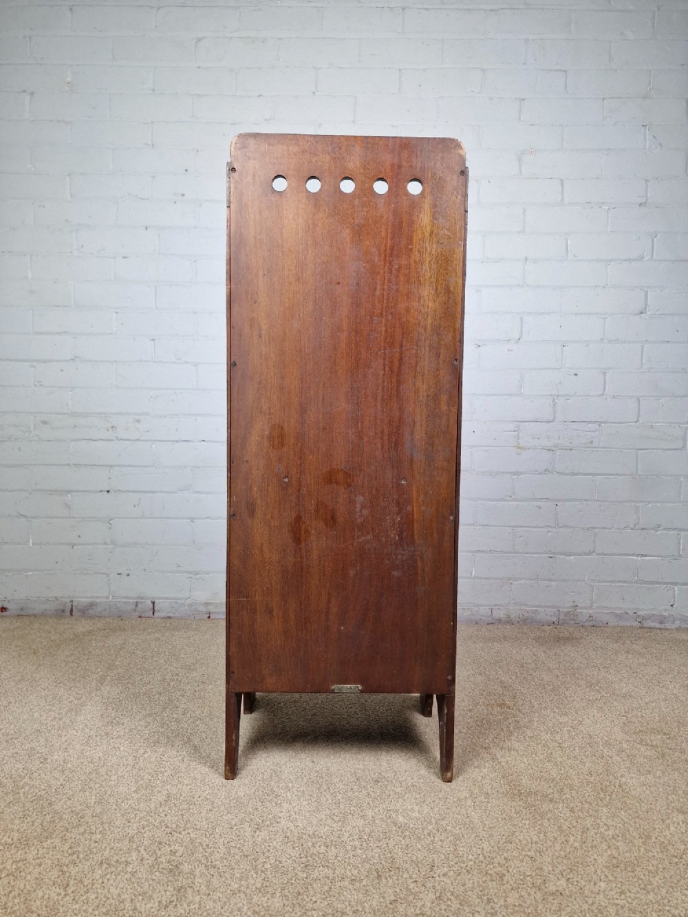 A tall Arts and Crafts brown oak magazine rack featuring three tiered compartments, circular cut-out details at the top, and integrated side carry handles. View V
