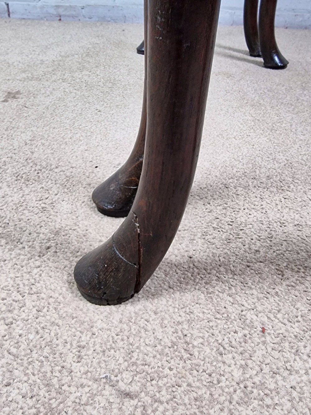 An 18th-century Georgian dark oak gateleg table with hinged leaves and slender tapered legs ending in pad feet. View II