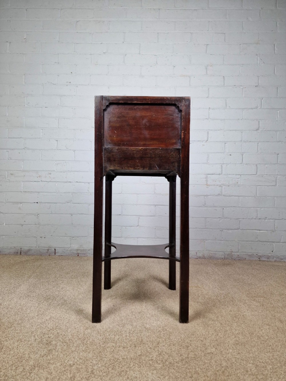 A tall Georgian dark mahogany bedside cabinet with a single door cupboard, straight legs, and an arched lower X-stretcher shelf. View VIII